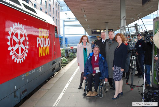 Barbara Groth, governor of District 1940 (standing, far right), Rotarians, and friends welcome the End Polio Now locomotive to Hamburg, Germany, on 26 October, at the start of its nationwide 12-month tour.